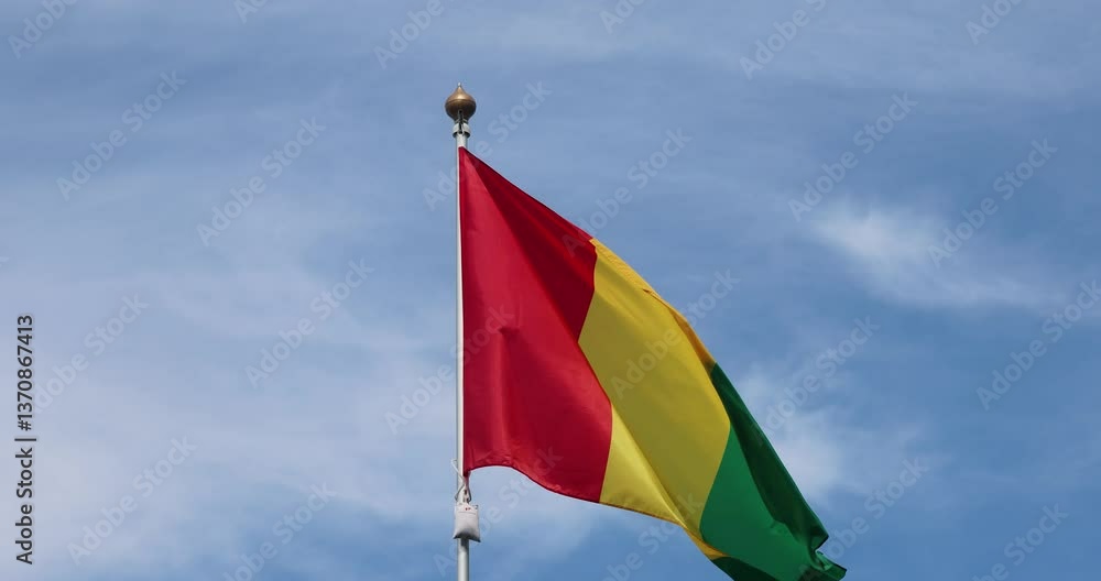 Flag of Guinea. Guinea national flag fluttering in the wind. Close-up. Great for news. Guinea flag against blue sky. 4K video. Flag of Guinea. Guinea national flag fluttering in the wind. Close-up. Great for news. Guinea flag against blue sky. 4K video.
