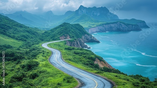 Coastal Road and Majestic Mountains: Capture the essence of wanderlust as a winding road snakes along a rugged coastline, flanked by lush green hills and towering mountains shrouded in mist.