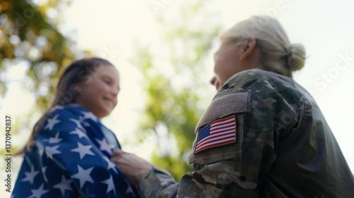 Wallpaper Mural US soldier mother wraps daughter in flag, sharing love and pride for country Torontodigital.ca