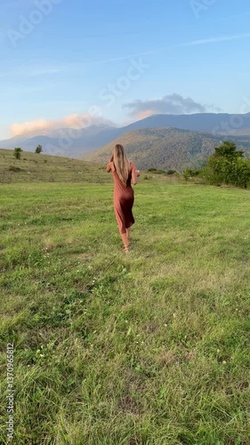 young woman walking in a field
