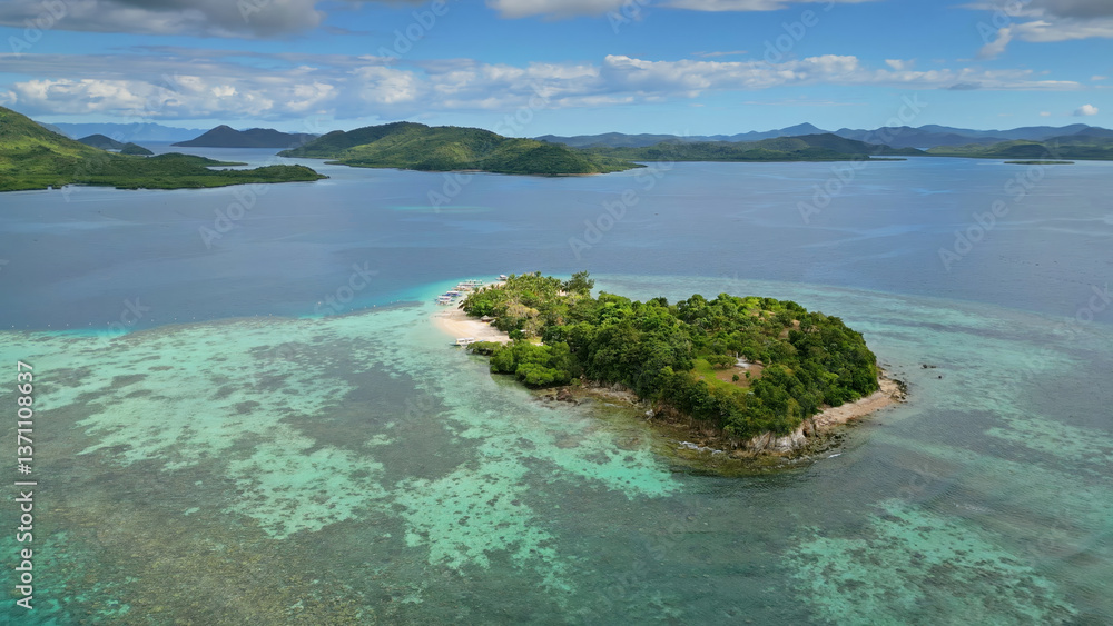 Fototapeta premium Small tropical island surrounded by distant islands