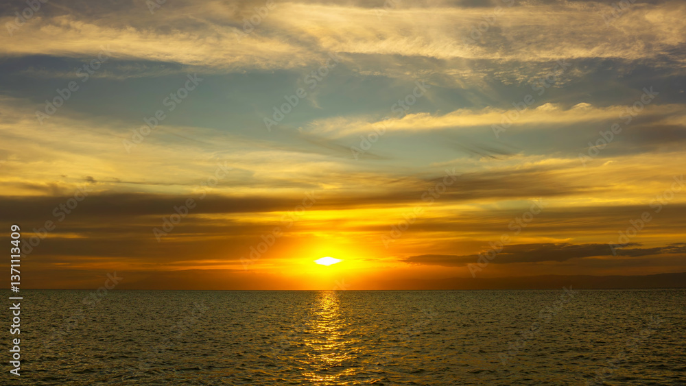 Fototapeta premium Stunning sunset over calm ocean waters