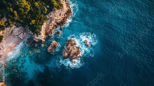 Fototapeta Naklejka Na Ścianę i Meble -  Aerial view of ocean waves against rocky shoreline