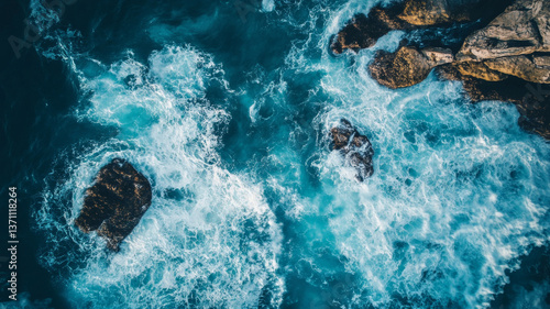 Fototapeta Naklejka Na Ścianę i Meble -  Aerial view of ocean waves crashing against rocky shoreline