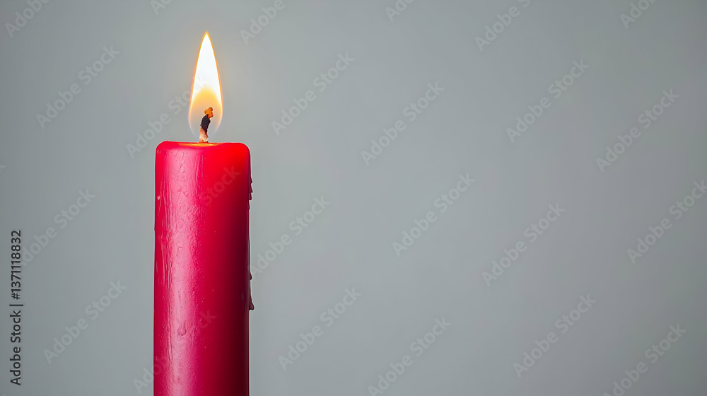 Single Red Candle With Flame Against Gray Background Single Red Candle With Flame Against Gray Background