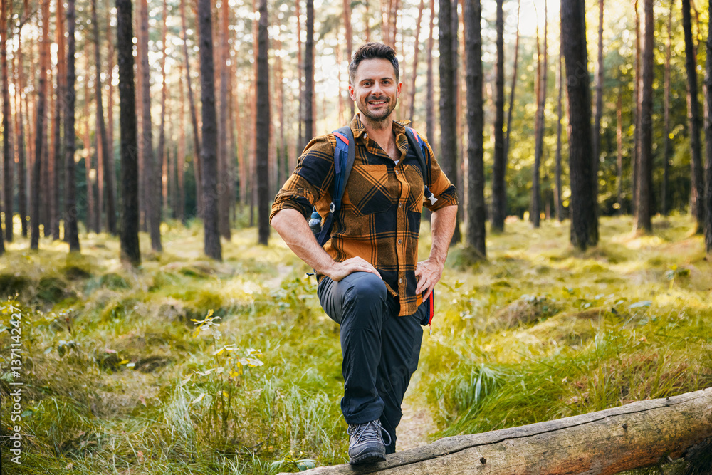 Hiker standing in forest looking at camera Hiker standing in forest looking at camera