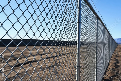 Close-up of chain link fence in a rural setting
