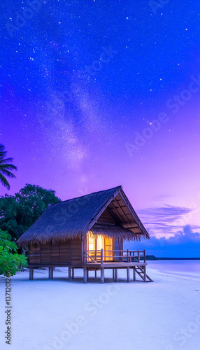 Tropical beach bungalow at night under starry sky