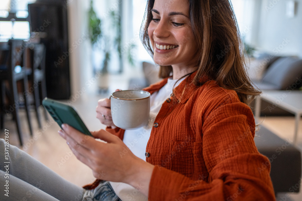 Woman drinking coffee and using smartphone at home Woman drinking coffee and using smartphone at home