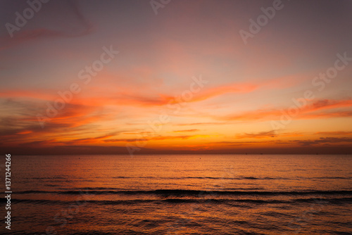 Beautiful bright stunning romantic sunset or sunrise on the horizon of clouds and the turbulent Black Sea of ​​the Krasnodar Territory in the tourist village of Anapa.