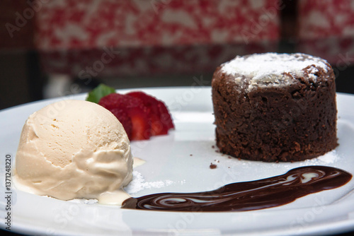 Delicious chocolate fondant with strawberry, chocolate sauce and walnut ice cream, desserts
