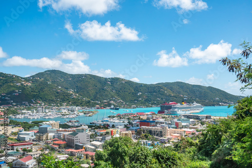 Stunning aerial view of Road Town, Tortola, British Virgin Islands, with vibrant coastal city, lush green hills, turquoise harbor, and large cruise ship docked at the port, Caribbean (February 2025) 
