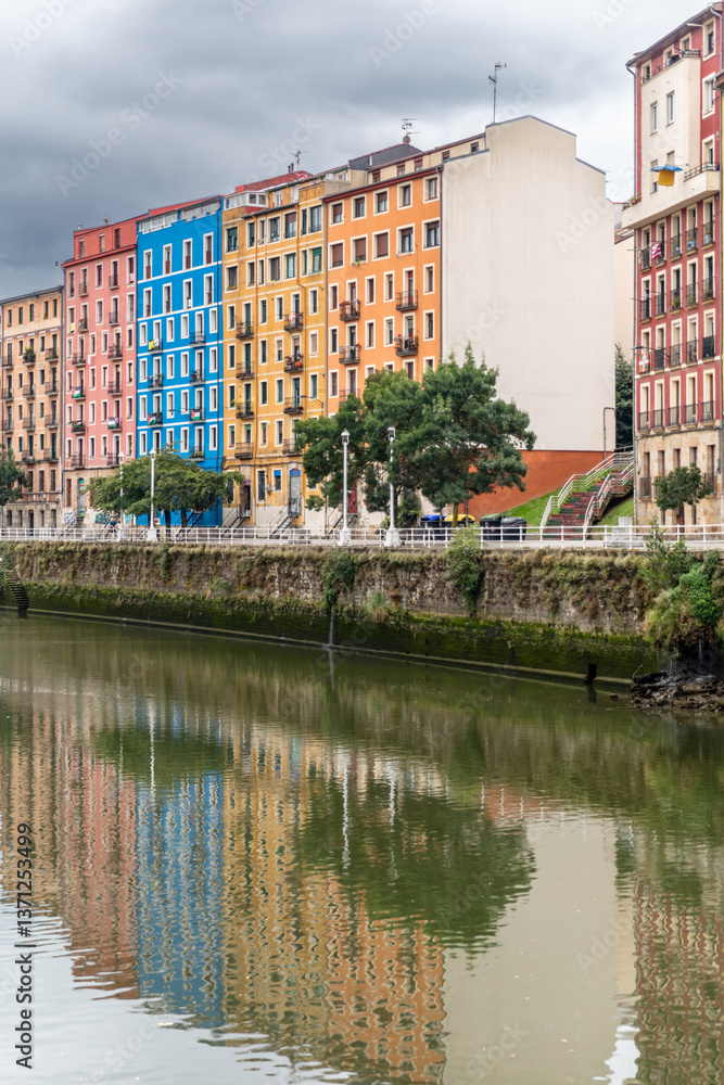 Fototapeta premium Vibrant riverfront buildings in Bilbao