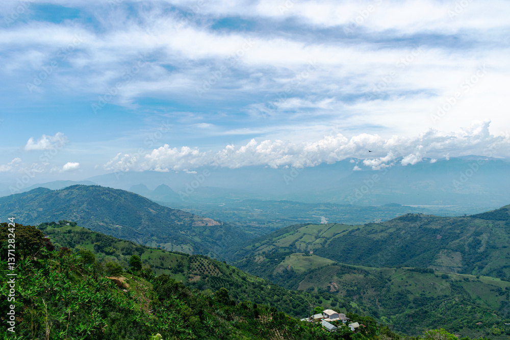 Obraz premium Breathtaking Panoramic View of the Green Mountainous Landscape of Colombia with Cloudy Sky