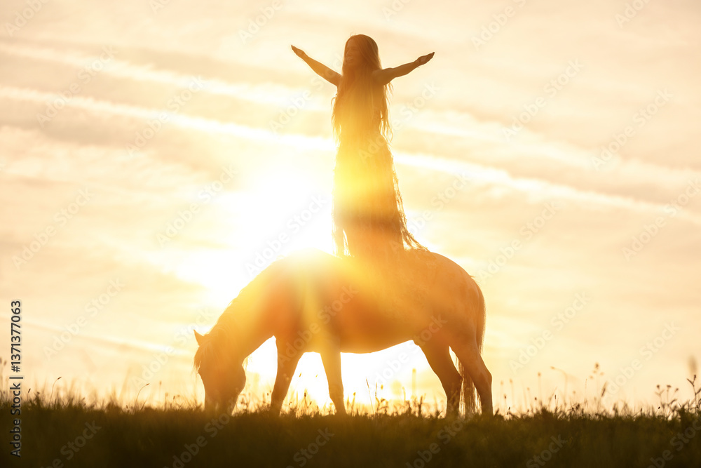 A female equestrian and her horse interacting together. Romantic freedom sunset scene