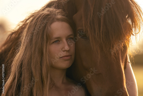 Obraz na płótnie A female equestrian and her horse interacting together. Romantic freedom sunset scene w salonie