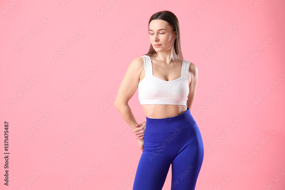 Woman in sportswear posing on pink background, space for text Woman in sportswear posing on pink background, space for text