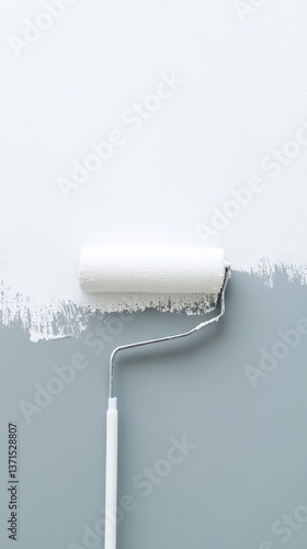 A paint roller is on a wall with paint on it. The roller is white and has a silver handle