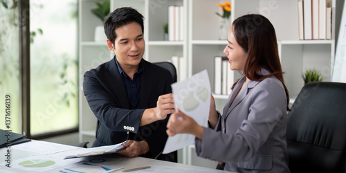 Wallpaper Mural Professional Interaction and Financial Reporting. Colleagues exchanging insights while reviewing financial materials. Torontodigital.ca