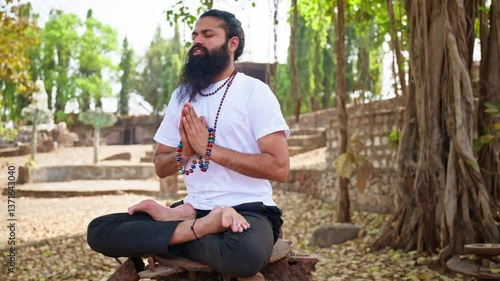 Spiritual devotee intones mantra holding energy bracelets