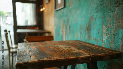 Rustic Wooden Table in Cozy Cafe with Colorful Turquoise Wall and Soft Natural Light