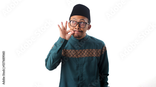 Quadro em tela Funny Asian Muslim man making a gesture with his hand as if zipping his lips, pl