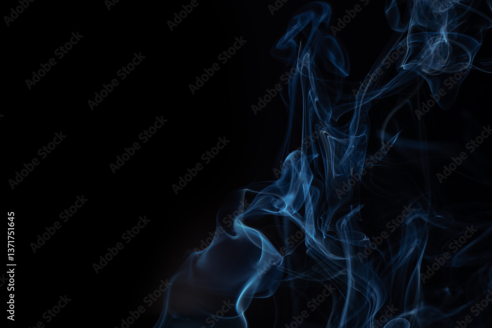Blue smoke swirls in abstract form on black background. Concept of mystery and creativity. Swirling, writhing smoke to overlay Blue smoke swirls in abstract form on black background. Concept of mystery and creativity. Swirling, writhing smoke to overlay