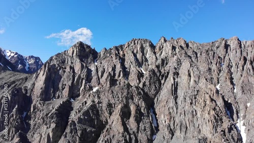 Top view of a large glacier and mountain peaks. Aerial drone showing a beautiful landscape with large rocks. eternal snow lies in the mountains. 