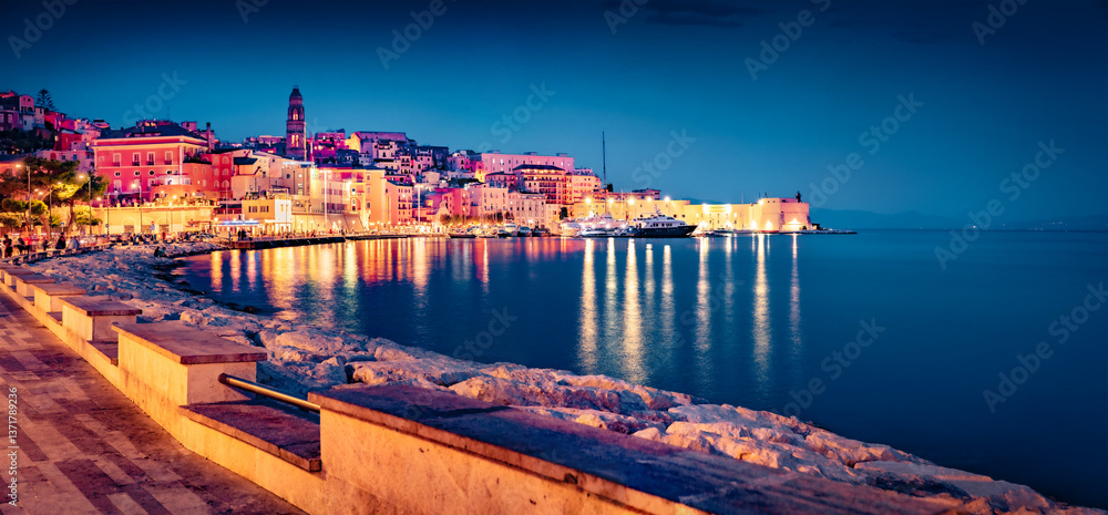 Dramatic summer cityscape of Gaeta port with Cathedral Basilica of Gaeta church on background. Panoramic evening view of coast of Mediterranean sea, Italy, Europe. Traveling concept background.
