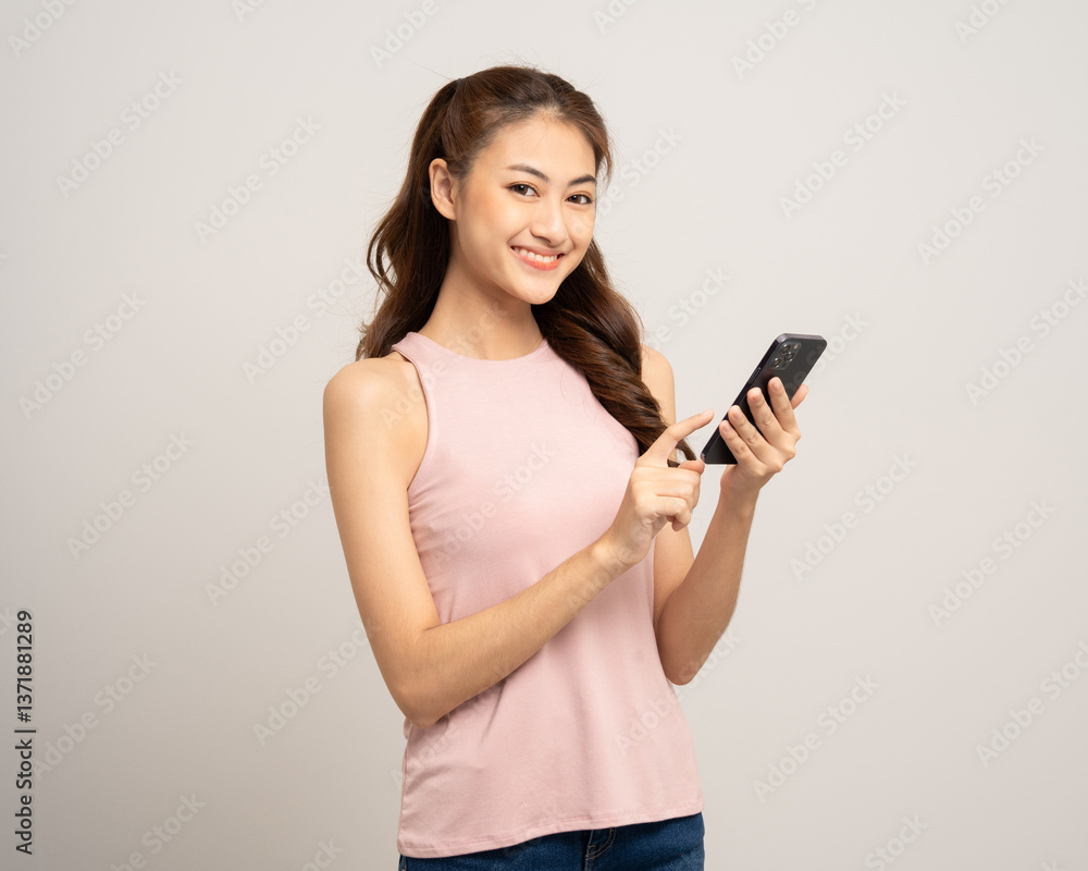 Pretty young asian woman using cellphone standing on isolated white background. Happy Excited Beautiful young asian shopping online payment with mobile phone. Playing game on smartphone Pretty young asian woman using cellphone standing on isolated white background. Happy Excited Beautiful young asian shopping online payment with mobile phone. Playing game on smartphone