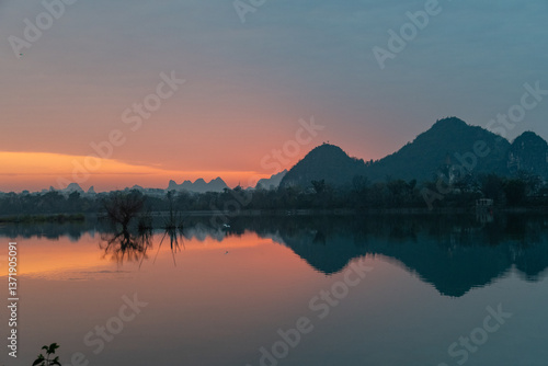 Golden Dawn on Li River: Misty Karst Peaks Reflecting in Mirror-Still Waters – Guilin's Ethereal Morning Symphony
