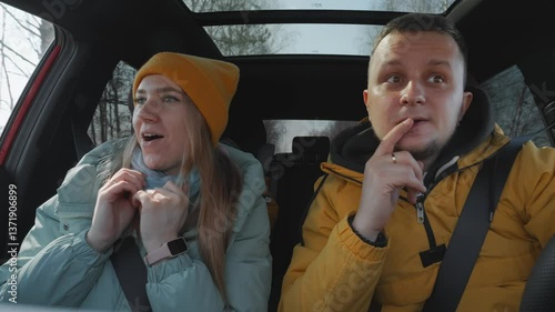 Young family with a child are driving a car, wide view from inside