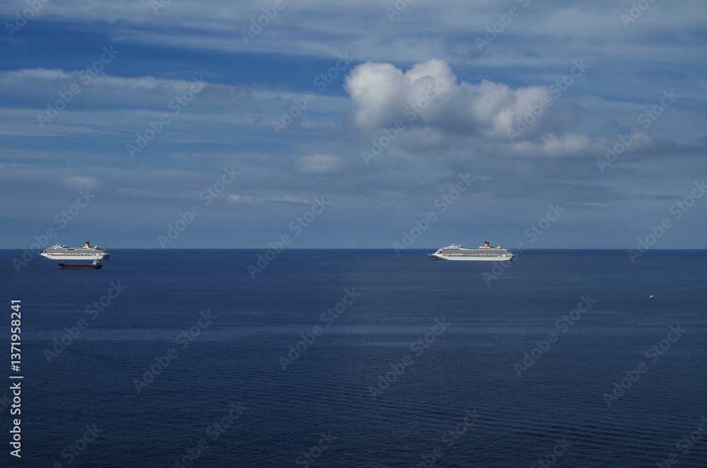 Mega family cruiseship cruise ship liners Favolosa and Fortuna anchored offshore of Civitavecchia Rome, Italy before reactived after Covid pandemic with other vessels in port and coastline