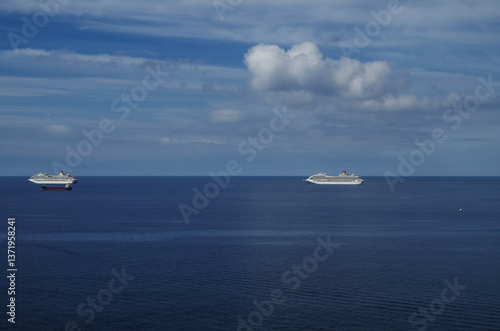 Obraz na płótnie Mega family cruiseship cruise ship liners Favolosa and Fortuna anchored offshore of Civitavecchia Rome, Italy before reactived after Covid pandemic with other vessels in port and coastline w salonie