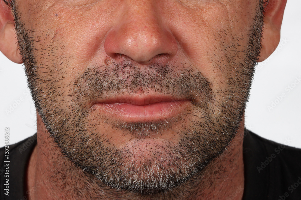 Fototapeta premium Lower face of a 45-year-old man with light stubble, showing natural facial texture