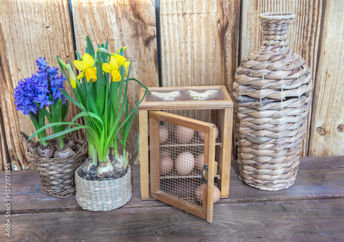chicken eggs in a decorative box  put on a table next to flower potted and a ...