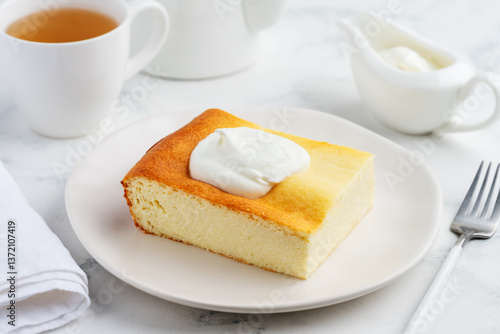 Cottage cheese casserole with sour cream on a plate for breakfast. Delicious healthy food. Selective focus