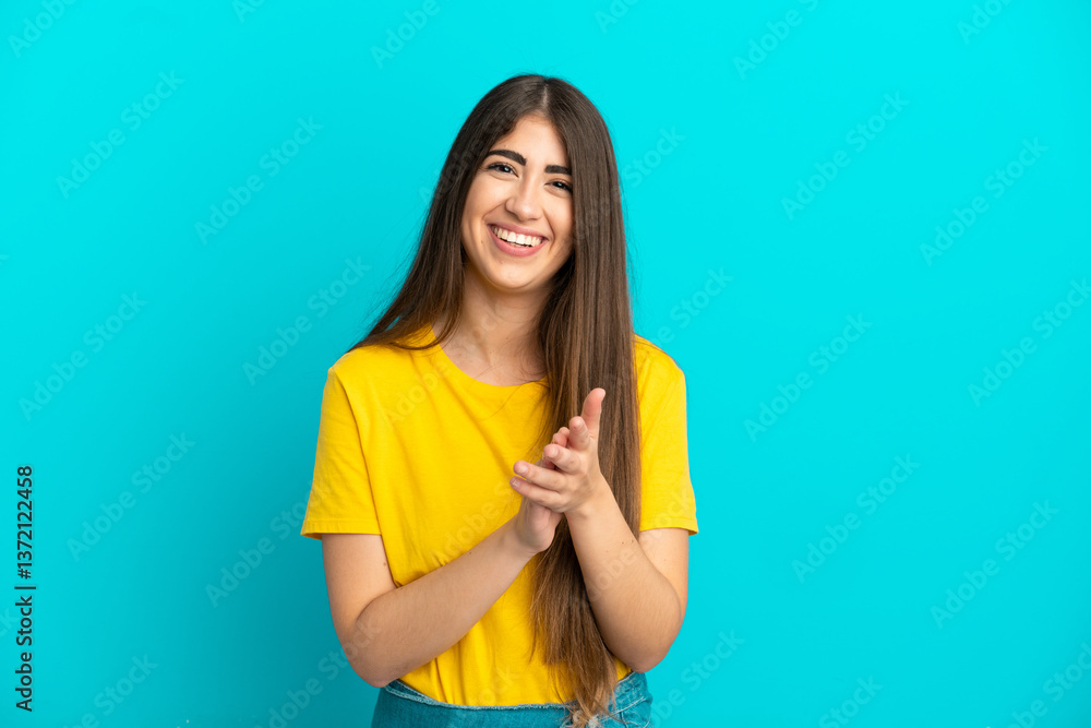 Young caucasian woman isolated on blue background applauding after presentation in a conference Young caucasian woman isolated on blue background applauding after presentation in a conference