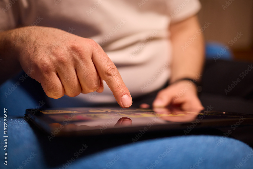 User Engaging with a Touchscreen Device While Relaxing in a Cozy and Inviting Setting User Engaging with a Touchscreen Device While Relaxing in a Cozy and Inviting Setting