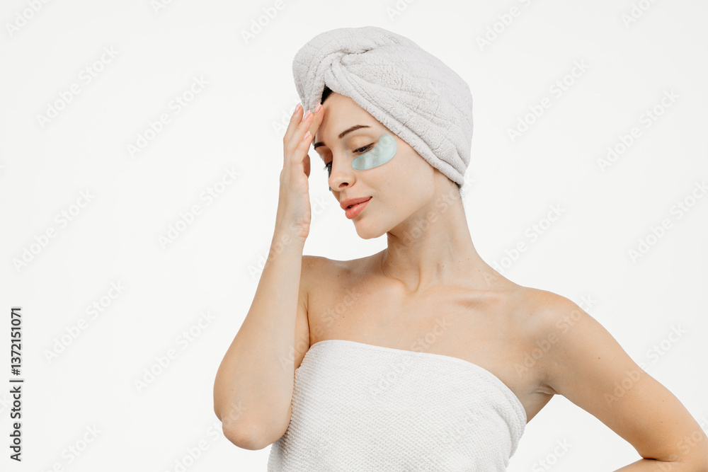 A portrait of a young woman with blue eyes wrapped in a towel after washing her hair. This image captures the essence of spa treatments, self-care, and deep relaxation. A portrait of a young woman with blue eyes wrapped in a towel after washing her hair. This image captures the essence of spa treatments, self-care, and deep relaxation.