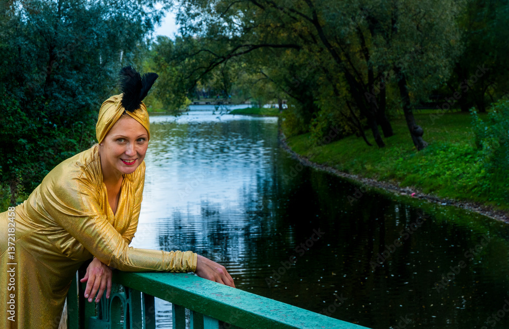 Beautiful girl wearing a turban and a stylized ethnic costume in the summer park. High quality photo