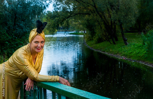 Obraz na płótnie Beautiful girl wearing a turban and a stylized ethnic costume in the summer park. High quality photo w salonie