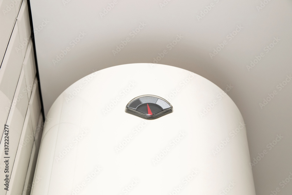 A white boiler hanging on a wall in a bright home interior, representing modern water heating technology and home efficiency