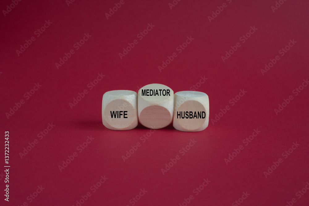 Concept words 'wife, husband and mediator' on wooden cubes. Symbol for solving a conflict with a mediator. Beautiful red background. Business concept.