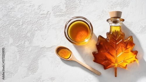 Maple syrup in leaf-shaped bottle with drizzling spoon