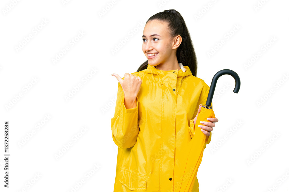 Young Arabian woman with rainproof coat and umbrella over isolated chroma key background pointing to the side to present a product Young Arabian woman with rainproof coat and umbrella over isolated chroma key background pointing to the side to present a product