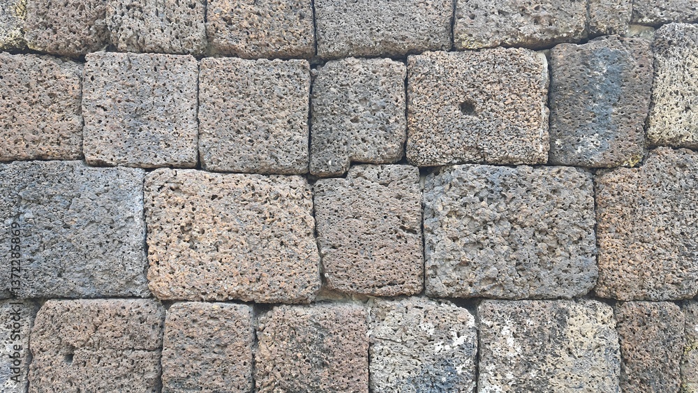 Ancient old brick stone texture pattern background. Ancient castle stone wall in Thailand, a fence made of large stones stacked in many layers. Ancient old brick stone texture pattern background. Ancient castle stone wall in Thailand, a fence made of large stones stacked in many layers.
