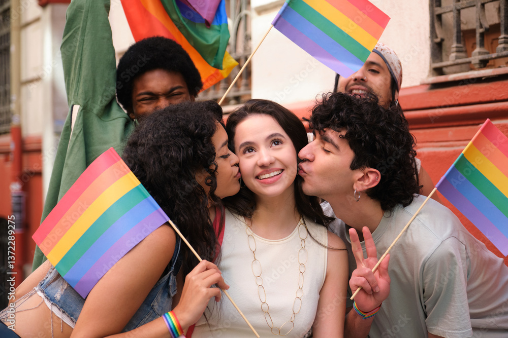 Group of friends celebrating and kissing a girl during a LGBT pride parade