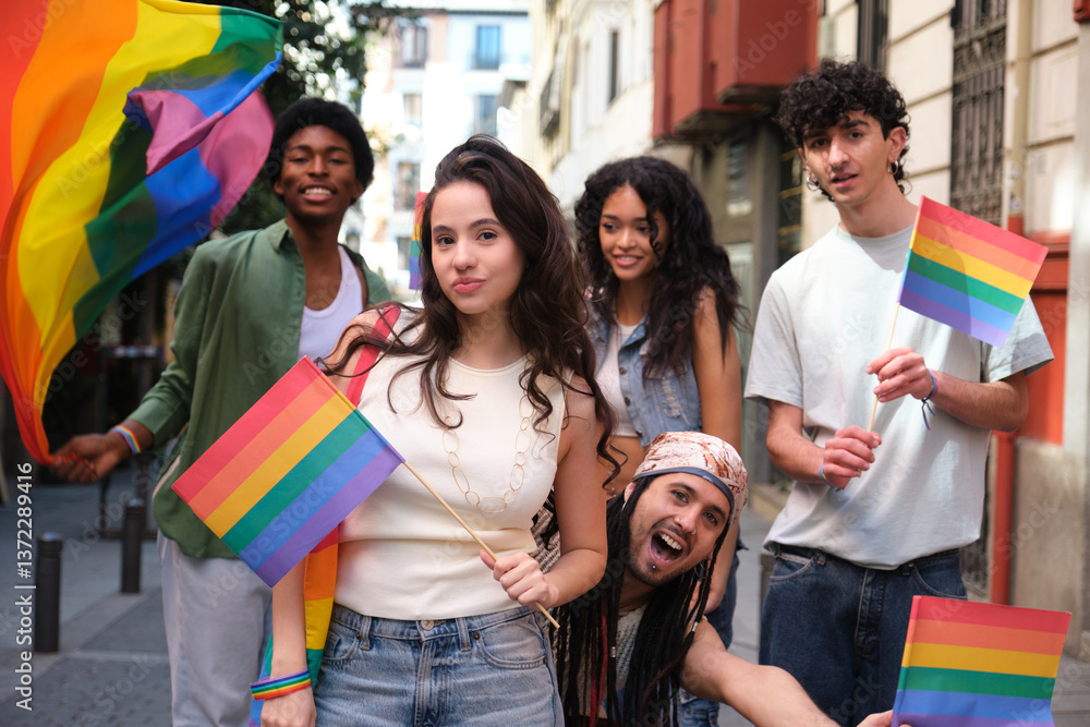 Young activists holding rainbow flags celebrating LGBT pride in the city