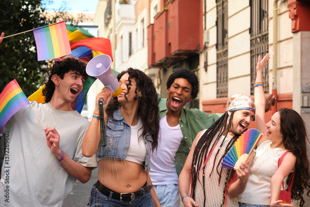 Happy multi ethnic friends marching together for lgbtq plus rights and holding rainbow flags and megaphone
